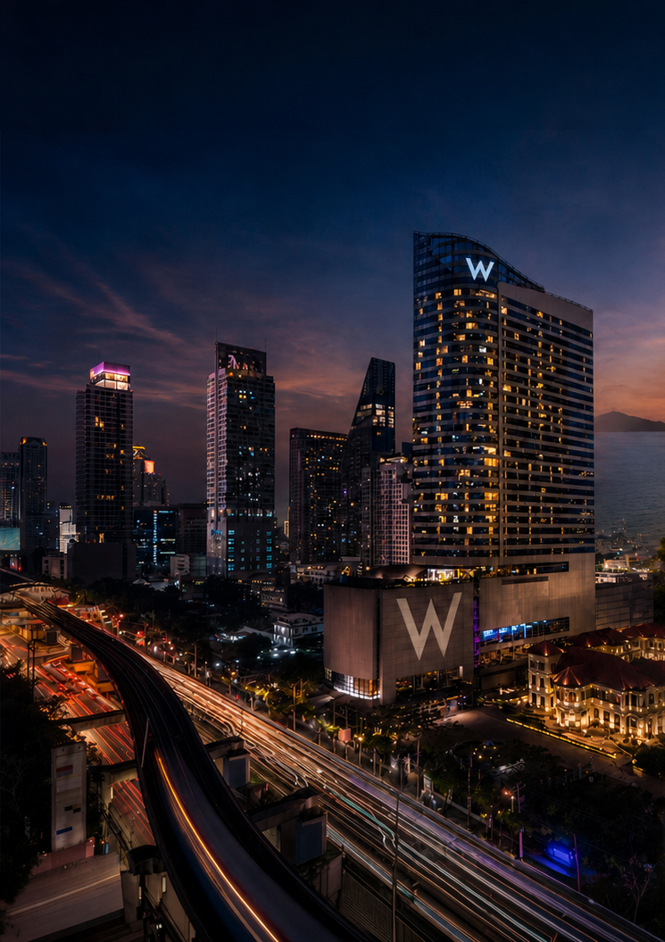 W Bangkok hotel illuminated against the city skyline at dusk